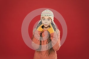 Frosty weather. Winter outfit. Cute model enjoy winter style. Little kid wear knitted hat. Little girl winter fashion