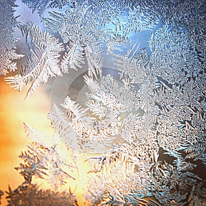 Frosty Window Glass with Natural Ice Patterns and Blurred Colorful Background. Winter Holidays Season, Fantasy World Concept