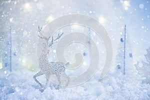 Frosty winter wonderland with toy deer, snowfall and magic lights.