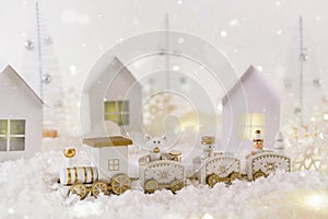 Frosty winter wonderland with toy train, snowfall and magic lights. Christmas greetings concept