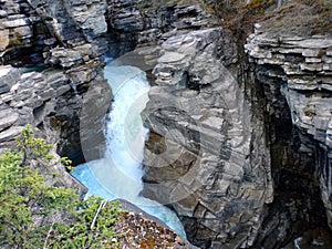 Frothing water gushing through a canyon at banff national park