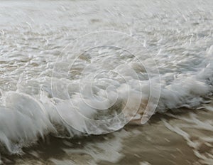Frothy beach waves in motion photo