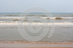 Frothy waves on beach