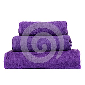 3 frotte towels purple color, bedroom towel white backgroung. Colorful violet bath towels isolated on white. Stack violettowels.