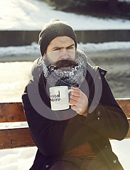 Frown man drinks from cup