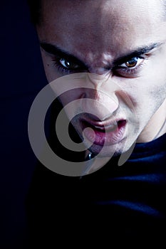 Frown of scary sinister evil vampire man photo