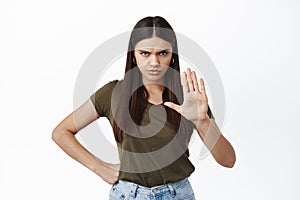 Frowning angry woman trying to stop person, stretch out hand to forbid or block, saying no, prohibit something bad