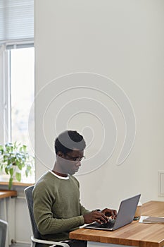 Frowning Businessman Working on Laptop