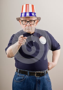 Frowning patriotic man in American flag hat