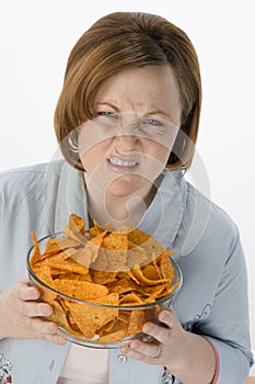 Frowning Woman With Bowl Of Nachos