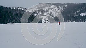 Frozen alpine lake covered in this snow