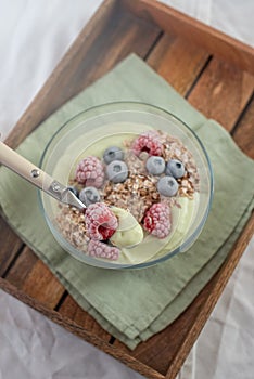 Frozen avocado smoothie bowl with frozen berries