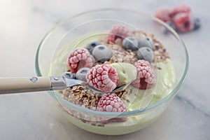 Frozen avocado smoothie bowl with frozen berries