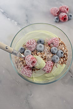 Frozen avocado smoothie bowl with frozen berries