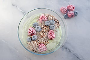 Frozen avocado smoothie bowl with frozen berries