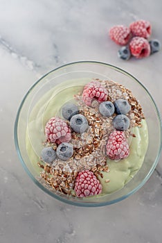 Frozen avocado smoothie bowl with frozen berries