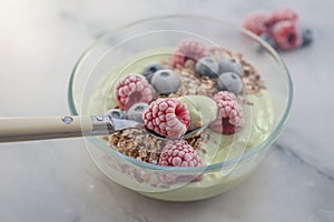 Frozen avocado smoothie bowl with frozen berries