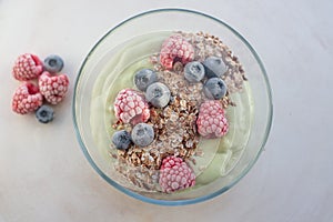 Frozen avocado smoothie bowl with frozen berries