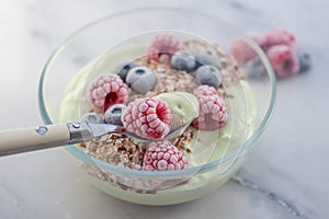 Frozen avocado smoothie bowl with frozen berries