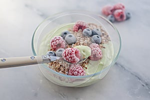 Frozen avocado smoothie bowl with frozen berries