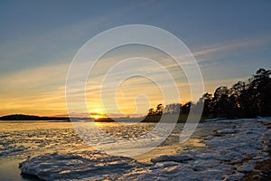 Frozen beach and icy sea on a sunset in Ruissalo, Finland.