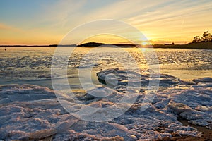 Frozen beach and icy sea on a sunset in Ruissalo, Finland.