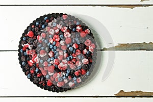 Frozen berries in a homemade cake form. The concept: homemade cakes. blueberries, raspberries, currants and others