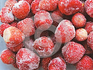 Frozen berries.Top view. Frozen delicious Strawberries, closeup. Assorted frozen berries background. Strawberries on blue