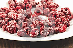 frozen berries used on a dish /frozen raspberry on a white dish, selective focus