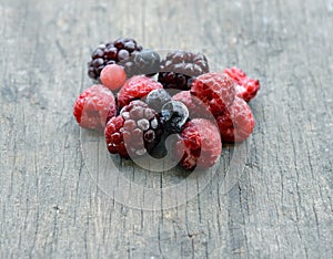 Frozen berries on wooden background