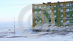 Frozen block of flats in Siberia. Tiksi .Painted blocks of Russia. Abandoned building in Tiksi