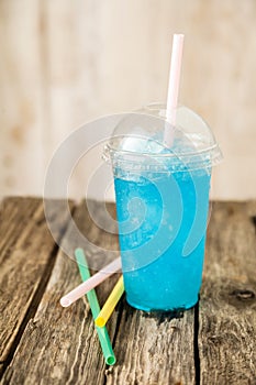 Frozen Blue Slushie in Plastic Cup with Straw