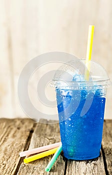 Frozen Blue Slushie in Plastic Cup with Straw