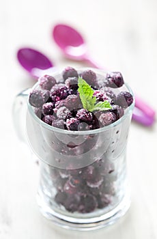 Frozen blueberries in a glass