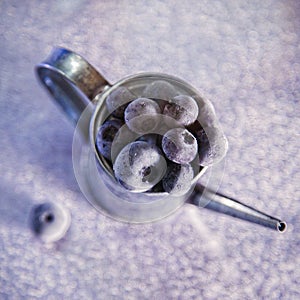 Frozen blueberries on a watering can