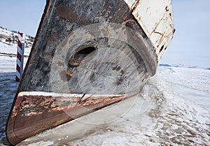 Frozen boat at the shore