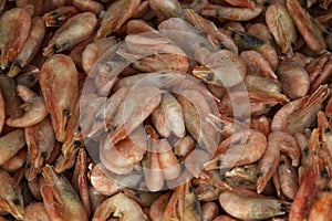 Frozen boiled shrimp in a container at the market. Seafood and healthy foods. Background. Topvid