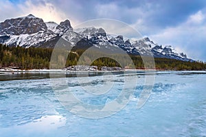 Frozen Bow River Through Canmore Mountains