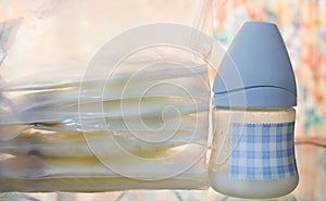 Frozen breast milk in storage bags and baby bottle