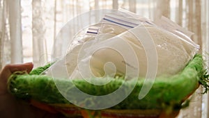 Frozen breast milk in storage bags in the basket