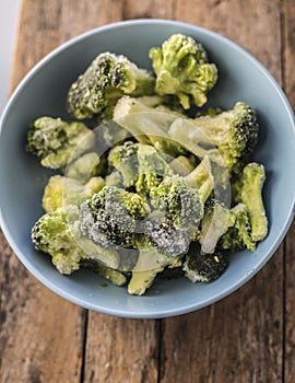 Frozen broccoli in blue bowl