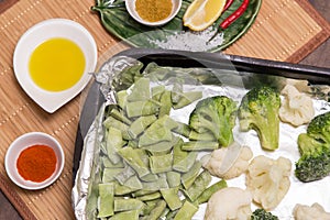 Frozen broccoli and cauliflower for cooking in foil in oven with spices and oil. Vegan vegetarian healthy diet food