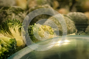 frozen broccoli florets and brussel sprouts inside freezer fridge closeup