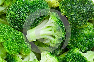 Frozen broccoli florets close up, top view