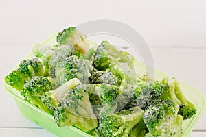 frozen broccoli vegetables in plastic storage containers. Stocks of meal for the winter