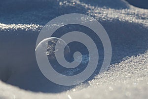 Frozen bubble on the snow during deep and cold . Slovakia