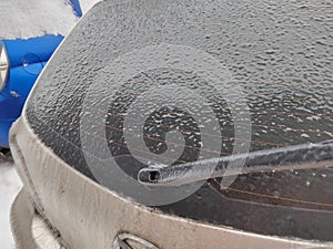 Frozen car. Car on the street covered by icy rain. freezing rain ice coated car.