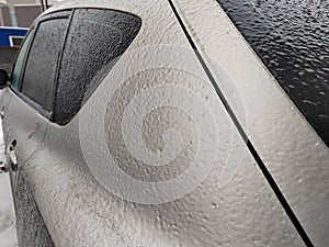 Frozen car. Car on the street covered by icy rain. freezing rain ice coated car.