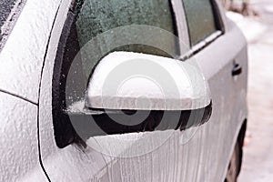 A frozen car covered with ice. How to de-ice the frozen car, open a frozen shut car doors and avoid ice damage to car paint