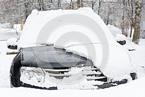 Frozen car covered with snow on a winter day